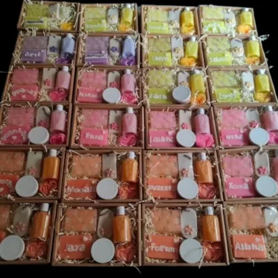 A large corporate order ready for dispatch. Each box is personalized with a name and contains a custom set of handmade soaps, candles, and body wash.