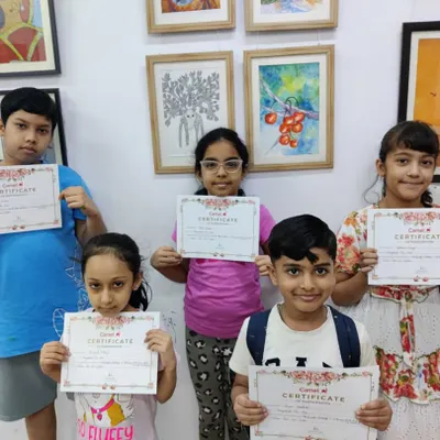 Proud graduates of our one-month summer vacation camp! Every student receives a certificate to celebrate their hard work and creative journey.