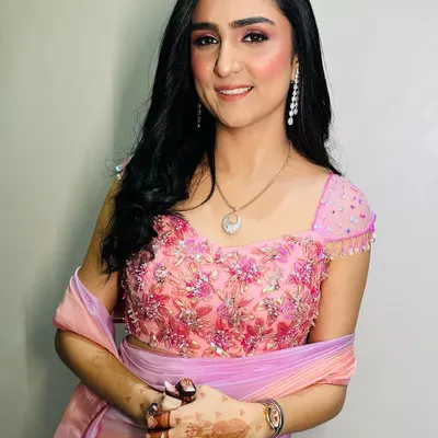 This is a perfect example of a soft and pretty Roka makeup look. I used shades of pink on the eyes and cheeks to create a fresh, youthful glow that beautifully complements her pink and lavender outfit.