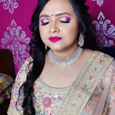 A perfect engagement look featuring dramatic purple and pink eyeshadow, a bold magenta lip, and a beautiful diamond choker. The half-up, half-down hairstyle with soft curls completes this glamorous look.
