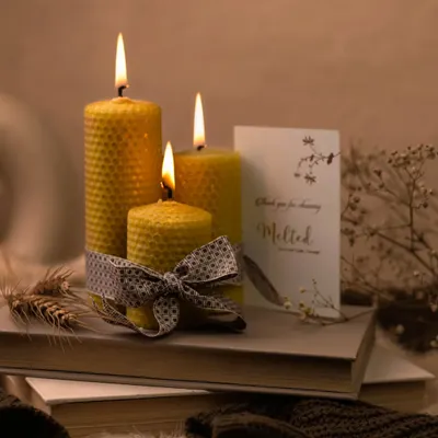 The golden glow of these lit beeswax candles creates a warm and inviting atmosphere. I styled them on a stack of books with cozy textiles to capture a perfect moment of hygge and tranquility.