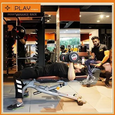 In my one-on-one sessions, I am right there with you. Here, I am spotting a client during a dumbbell bench press to ensure he maintains proper form and gets the most out of every single rep for chest development.
