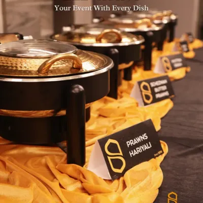 We elevate your event with every dish. Our buffet lines are elegantly set up with black and gold accents, featuring dishes like Prawns Hariyali and Schezwan Butter Prawns.