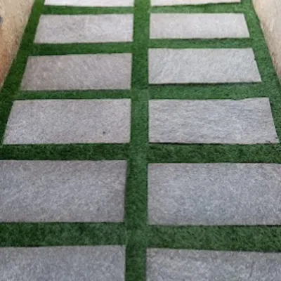 For a clean, modern look with no maintenance, I combine artificial grass with natural stone pavers. This is a perfect solution for walkways and patios.