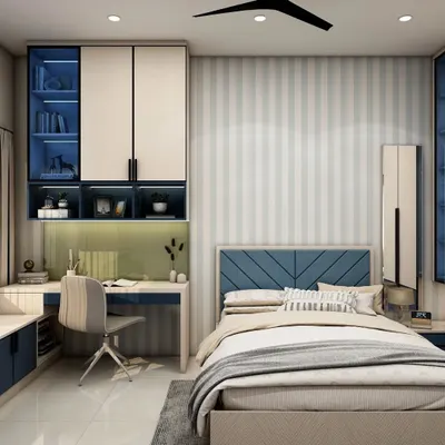 A perfect room for a growing child, this space features a built-in study desk with overhead storage and a cozy bed. The blue and white color scheme with striped wallpaper creates a classic, timeless look.