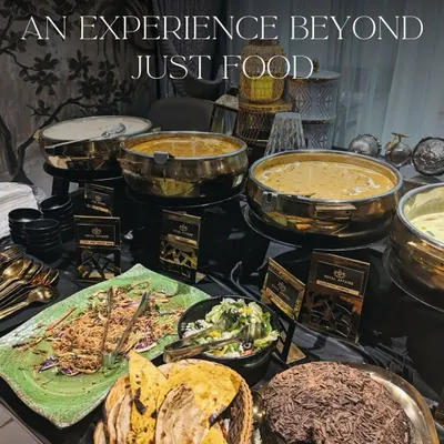 My buffet service is an experience beyond just food. This setup features my signature brass serving dishes, a variety of main courses and salads, and elegant decor, creating a complete and luxurious dining atmosphere.