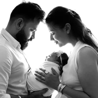 A beautiful, intimate moment between new parents adoring their baby. I love creating these classic, high-contrast black and white portraits that focus purely on the emotion and connection.