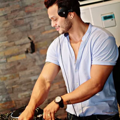 Turning knobs for a living. A simple, clean shot of me at the DJ console, focused on the mix. This captures the essence of my craft and passion for music.