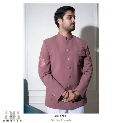 Our pastel pink Prince Coat, tailored in a classic Jodhpuri style. This front-facing view shows the clean button line and the subtle Resham embroidery on the pocket flap and sleeve.