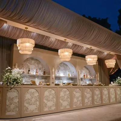 A stunning, full-length view of the custom bar from the "Ivory Dreamscape" event. The series of arched back-bar displays and tiered chandeliers creates a spectacular focal point for the evening.