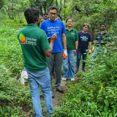 Our team guiding volunteers from Marsh India through a dense, forested area. We always start with a nature walk to help volunteers connect with the environment they are about to nurture.