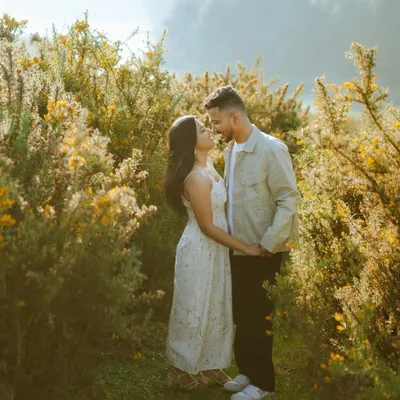 Bathed in the golden hour light of the hills, a couple shares a moment of quiet romance. These natural light portraits are perfect for telling your pre-wedding story.