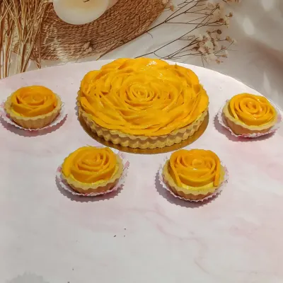 My mango tarts are a seasonal highlight, available in both a large, shareable size and as lovely individual mini tarts. Each one is a beautiful arrangement of fresh mango over a rich, creamy filling.