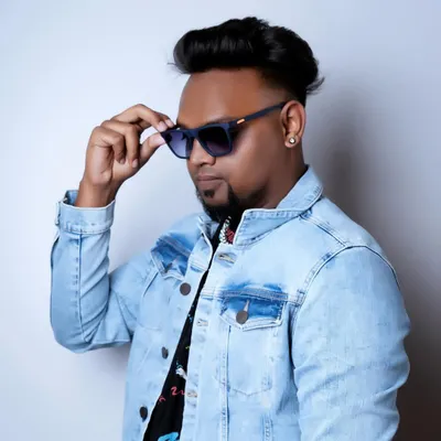 A clean studio shot reflecting my cool and confident style. The denim jacket and shades are part of my signature look.