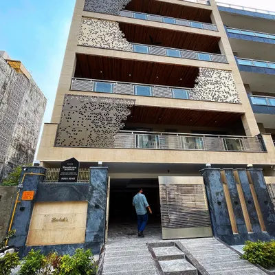 Here is a look at one of our completed residential projects in Gurgaon. I focused on creating a strong visual identity for the building by layering different materials like limestone, wood cladding, and a custom CNC-cut metal jali. The goal was to design a facade that is modern, sophisticated, and has a powerful street presence.