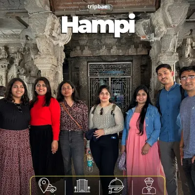 A group of travelers inside one of Hampi's magnificent stone temples. Our all-inclusive trips make exploring this vast historical site easy and fun.