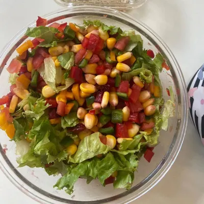 Our chopped vegetable salad is a rainbow in a bowl. It's loaded with fresh lettuce, sweet corn, and colorful bell peppers for a crunchy, light, and healthy meal.