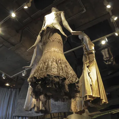 Mannequins displaying haute couture gowns appear to float within the Gaurav Gupta store. This low-angle shot emphasizes the verticality of the space and the way the sculpted interior directs the eye, turning fashion into a form of installation art.