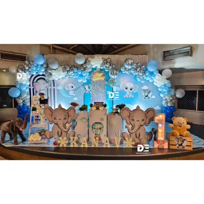 A dreamy baby elephant theme for a first birthday. I used a soft blue and silver color palette, cloud-like props, and cute elephant cutouts to create this magical sky-themed stage.