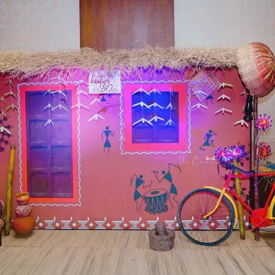 Our complete village-themed backdrop, ready for the 80th birthday celebration. We included authentic details like a retro cycle, earthen pots, and a grinding stone to evoke a sense of nostalgia.