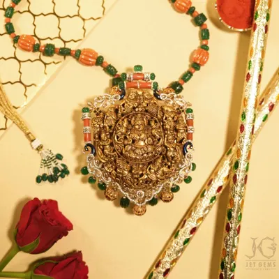 This is a piece of artistry that tells a story of gods and kings. A traditional temple jewellery necklace, hand-carved in gold and adorned with precious gems, it is more than an accessory; it is a wearable masterpiece of our culture.