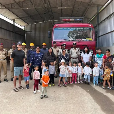 A proud moment for our campers and their families, posing with the firefighters at the local fire station. Field trips like this help children understand the important roles people play in our community.