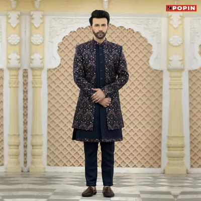 This dark navy Jodhpuri suit is a great example of modern royal attire. The jacket features a subtle, intricate print over a solid navy kurta, creating a sophisticated look for any evening celebration.