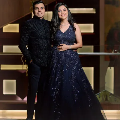 A classic engagement portrait of a couple, perfectly coordinated in their stunning blue and black outfits. We ensure that even posed shots feel natural and reflect your connection.