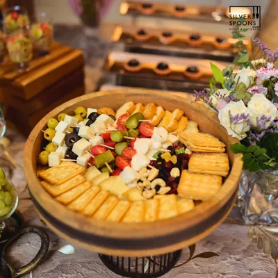 A closer look at our classic cheese platter, featuring a variety of hard and soft cheeses, crackers, nuts, and olives. This setup is perfect for corporate events and intimate birthday parties.