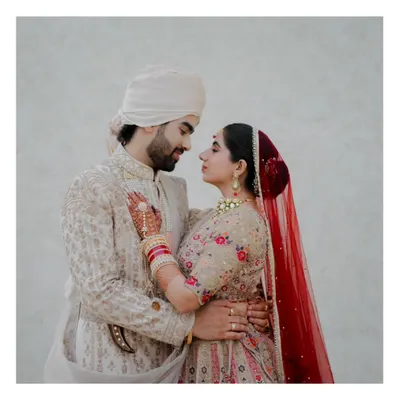 A perfect example of a cinematic portrait. The couple is lost in each other's eyes, creating an intimate and timeless image against a simple, clean background.