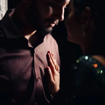 This is a close-up from a cinematic portrait session. I directed the couple to get close, focusing on the gentle touch and the quiet moment between them. The low-key lighting highlights their expressions and creates a very intimate feel.