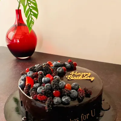A rich, decadent chocolate cake with a glossy ganache finish. I topped this one with a beautiful assortment of fresh berries, including blueberries and mulberries, for a perfect balance of sweet and tart flavors.