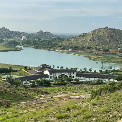 An aerial view showcases our retreat's unique location, embraced by a serene lake and the rugged beauty of the surrounding hills. This is the landscape that will be the backdrop to your healing.