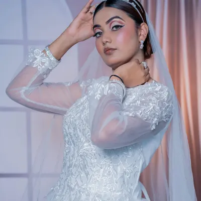A beautiful Christian bridal look featuring a classic white gown, elegant veil, and a pearl headband.