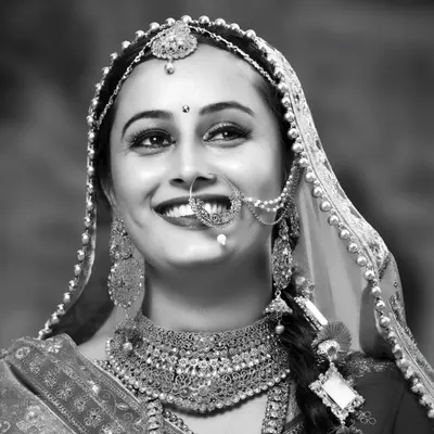 A joyful black and white portrait of a bride. Without color, her bright smile and sparkling eyes become the absolute focus of the image.