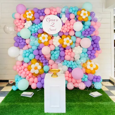 This "Two Sweet" balloon wall I created for Griva's second birthday is a perfect example of a custom photo backdrop. The pastel-colored balloons are arranged with daisy flower accents to create a beautiful and fun floral garden effect.