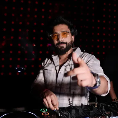 Pointing to the crowd, ready to drop the next beat. This is me in my element, connecting with the audience from behind the console.