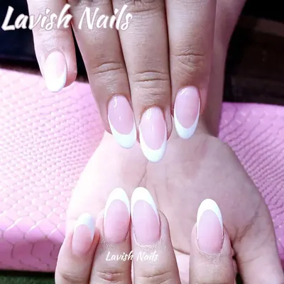 The quintessential classic French manicure on perfectly shaped oval nails, offering a clean, elegant, and timeless bridal look.