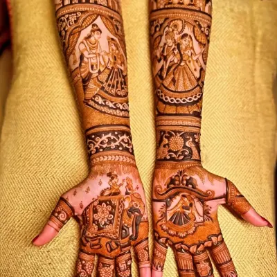 A classic love story of Radha and Krishna depicted on the forearms, with a doli scene on the palm. This is a popular choice for brides who want a blend of divine love and wedding tradition in their henna design.