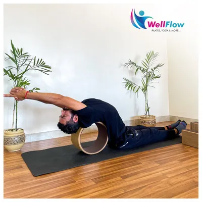 A yoga wheel is an excellent prop for opening the back and chest. Here, it is used to support a deep, restorative backbend, releasing tension in the spine.