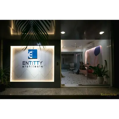 The entrance to our studio, where our backlit logo greets clients. The glass facade offers a glimpse into the creative and welcoming atmosphere we've cultivated inside.