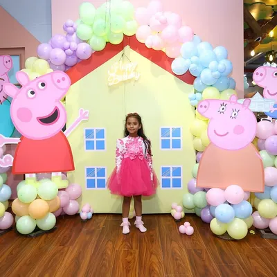 Welcome to the world of Peppa Pig. We create the perfect scene with a custom backdrop of Peppa's house, life-sized character cutouts, and a pastel balloon arch for a truly oink-tastic day.