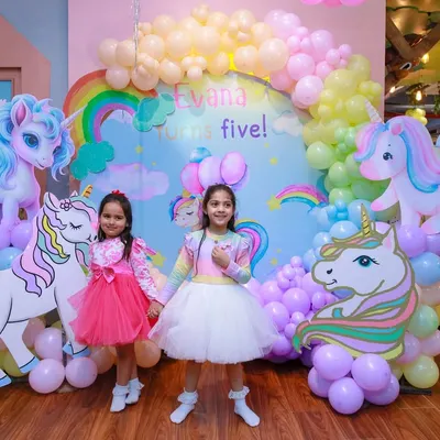 A beautiful unicorn-themed setup for a 5th birthday. We use a stunning backdrop, life-sized unicorn cutouts, and a pastel balloon cloud to create a whimsical and dreamy atmosphere.