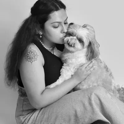 A sweet kiss for a beloved pet. Black and white photography beautifully emphasizes the emotional connection and tenderness in moments like this, creating a timeless piece of art.
