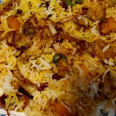 A close-up of my Veg Dum Biryani, slow-cooked to perfection. You can see the layers of long-grain basmati rice, mixed vegetables, and crispy fried onions.