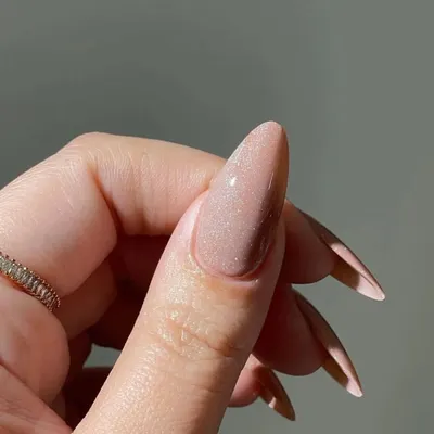 A close-up of my shimmering nude acrylic extensions. This beautiful, fine-milled glitter polish provides a sophisticated sparkle that catches the light without being overpowering, ideal for an elegant bridal look.