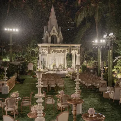 This is what I mean by creating a dream. For this magnificent outdoor wedding, I designed a breathtaking scene with a grand, illuminated mandap set against a lush garden, using soft lighting and elegant seating to craft an atmosphere of pure magic.