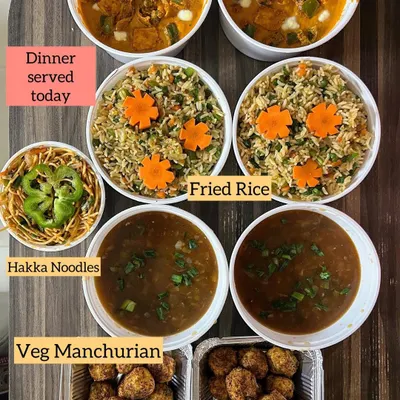 A complete Indo-Chinese dinner spread, featuring Veg Manchurian, Hakka Noodles, Fried Rice, and Paneer Tikka Masala for a fusion touch.