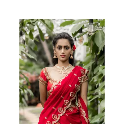 A vision in red, this bridal lehenga is designed for the classic bride. The rich orange-red brocade is paired with a maroon blouse featuring stunning zardosi and bead embroidery, creating a look of regal splendor.