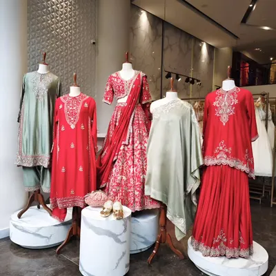 Style, curated. This in-store display showcases a range of festive silhouettes, from a vibrant red lehenga to modern kurta sets in sage green. It’s a glimpse into the variety I offer.